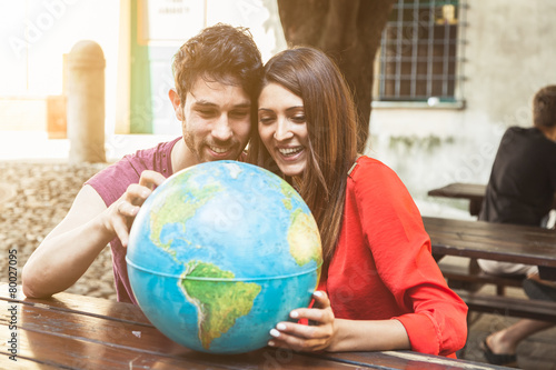 Young couple looks the world map