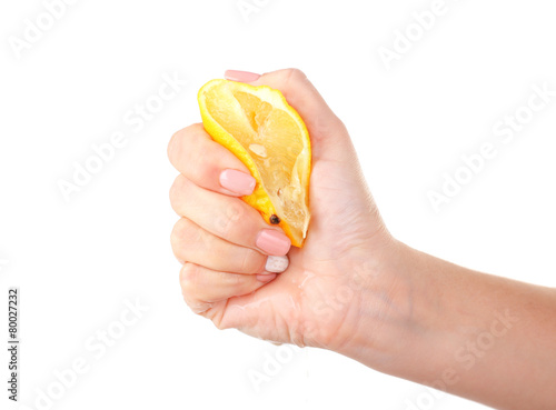 Female hand squeezing lemon isolated on white