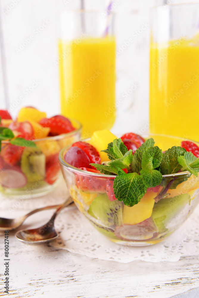 Fruit salad with mint and orange juice in glassware Fruit salad with mint and orange juice in glassware