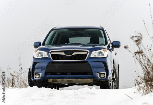 Powerful offroader car view on winter background
