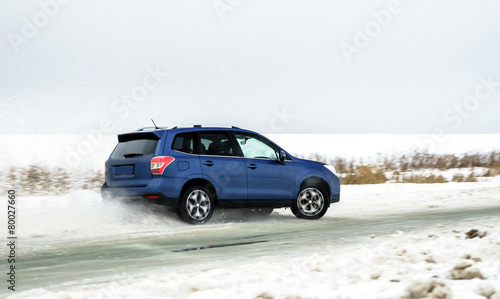 Powerful offroader car sliding by lake ice © 31etc
