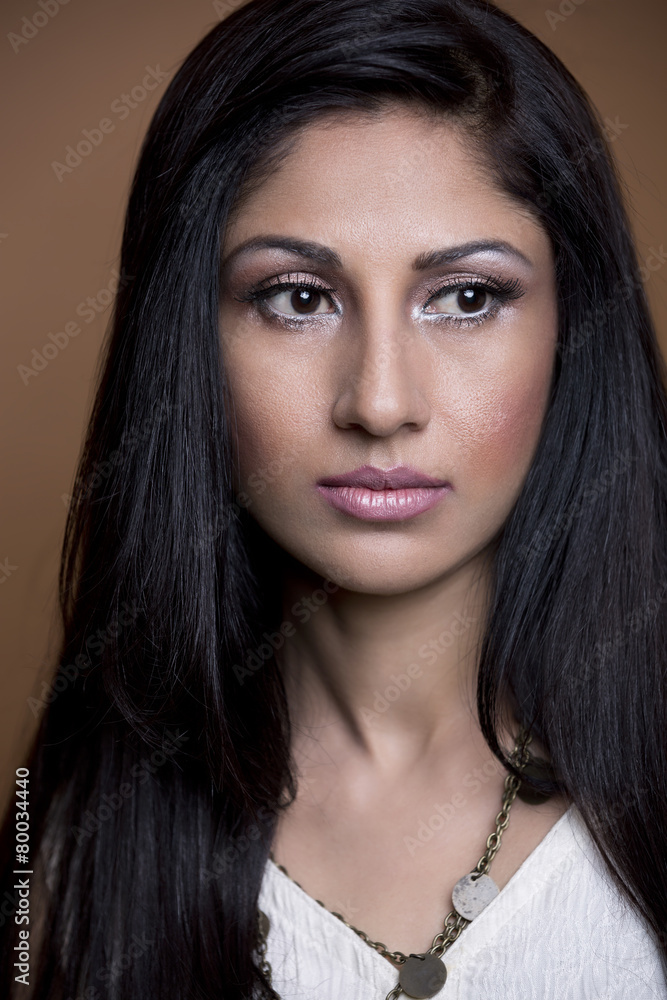 Close-up portrait of a young woman wearing white shirt. Studio s Close-up portrait of a young woman wearing white shirt. Studio s