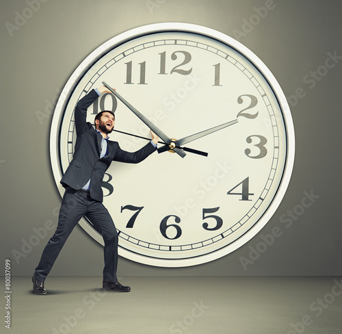 Fotografija businessman picks up the clock