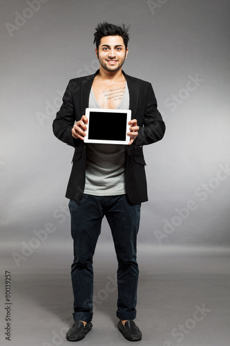 Man with digital touch screen over grey background