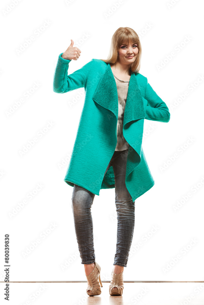 woman green coat making thumb up sign woman green coat making thumb up sign