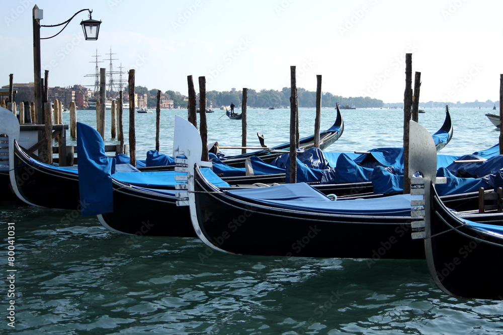 Traditional gondolas in the sea, symbol of Venice.