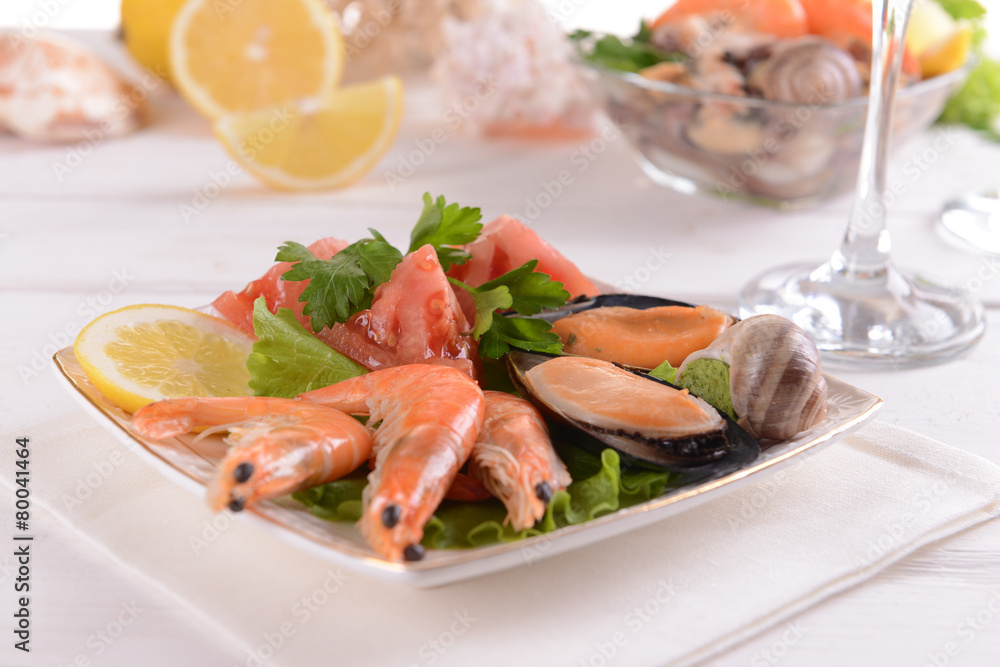 Tasty seafood on plate on table close-up Tasty seafood on plate on table close-up