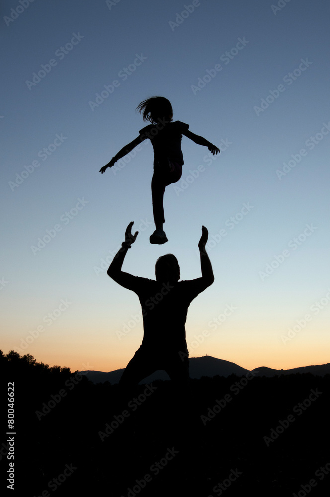 Playful silhouettes of father and daughter Playful silhouettes of father and daughter