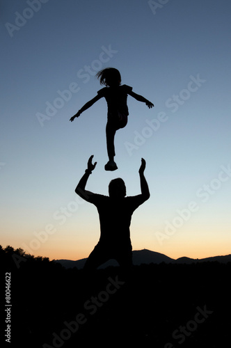 Playful silhouettes of father and daughter