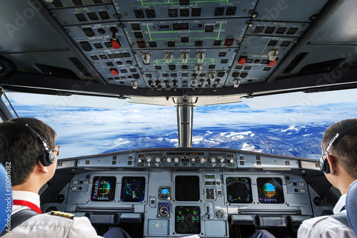 Billede på lærred Pilots in the plane cockpit and cloudy sky