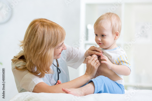 doctor woman examining child boy with stethoscope