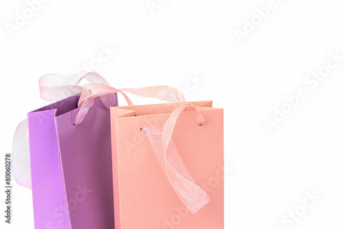 Pastel pink and lilac colorful shopping bags isolated on white