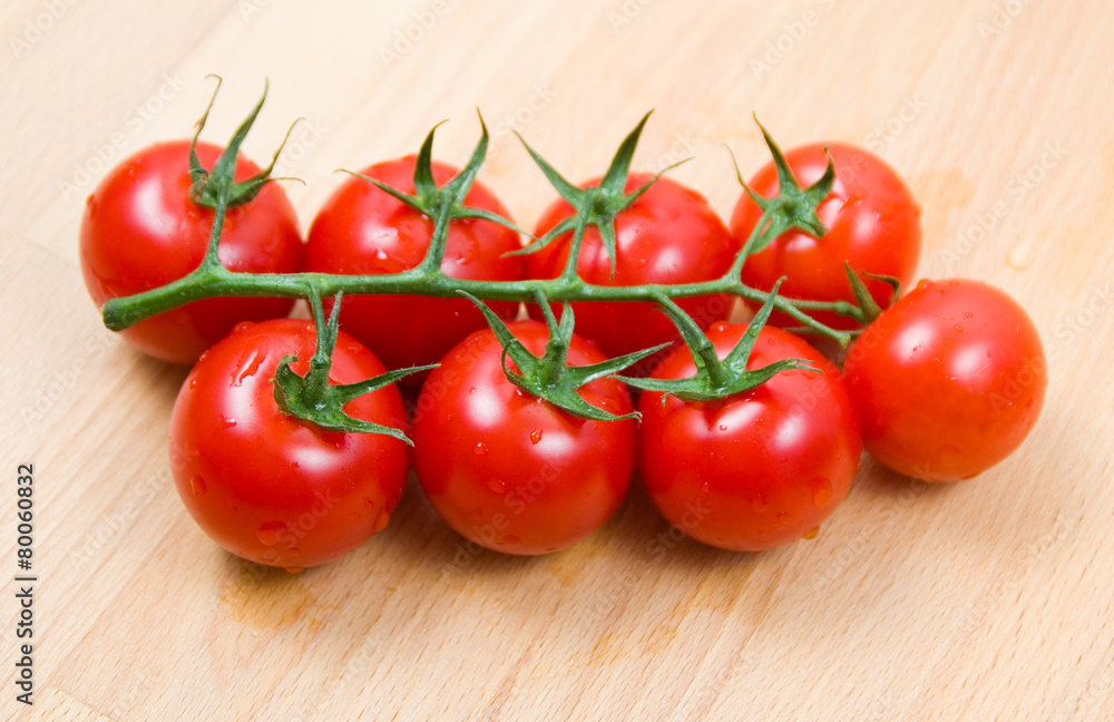 Tomatoes cherry branch on a wooden board Tomatoes cherry branch on a wooden board