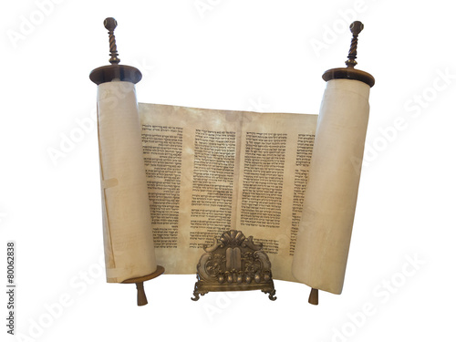 The Jewish Torah scroll and a gold menorah candle support isolat