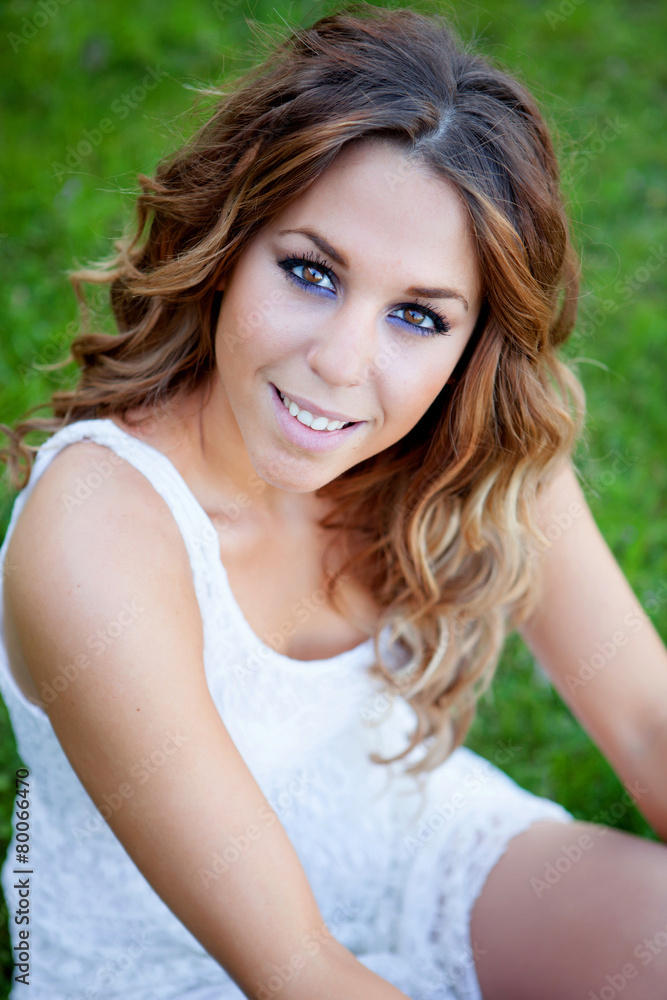 Cool pretty woman sitting on the grass Cool pretty woman sitting on the grass
