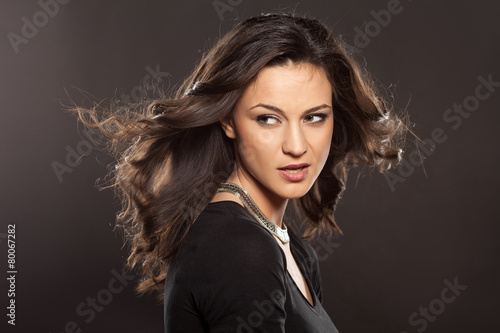 marvelous beautiful brunette posing in the studio - hair styling