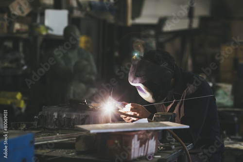 Man with mask welding in a workshop