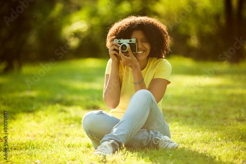 Young woman enjoying summer and photographing