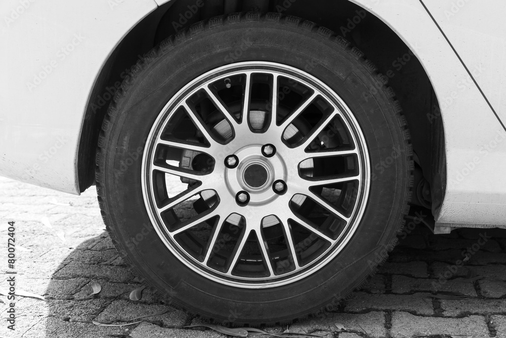 White modern car fragment with wheel on steel disc