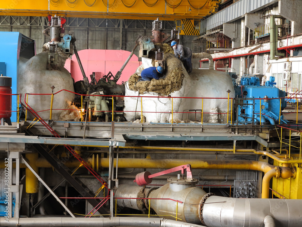 Steam turbine during repair, machinery, pipes at a power plant