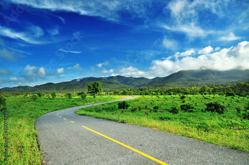 Country road against blue sky background