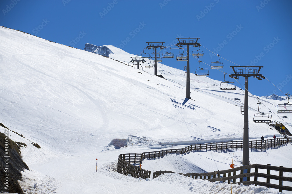 Winter mountains panorama with ski lifts on a cloudy day Winter mountains panorama with ski lifts on a cloudy day