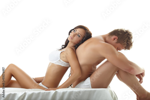 Tableau sur toile Sexy girl lying on upset guy. Concept of impotence