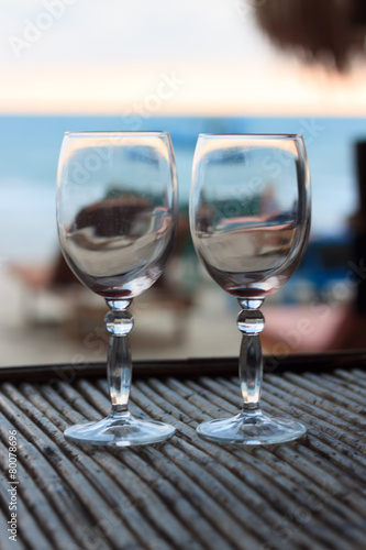 Beach evening on the sunset with two glasses