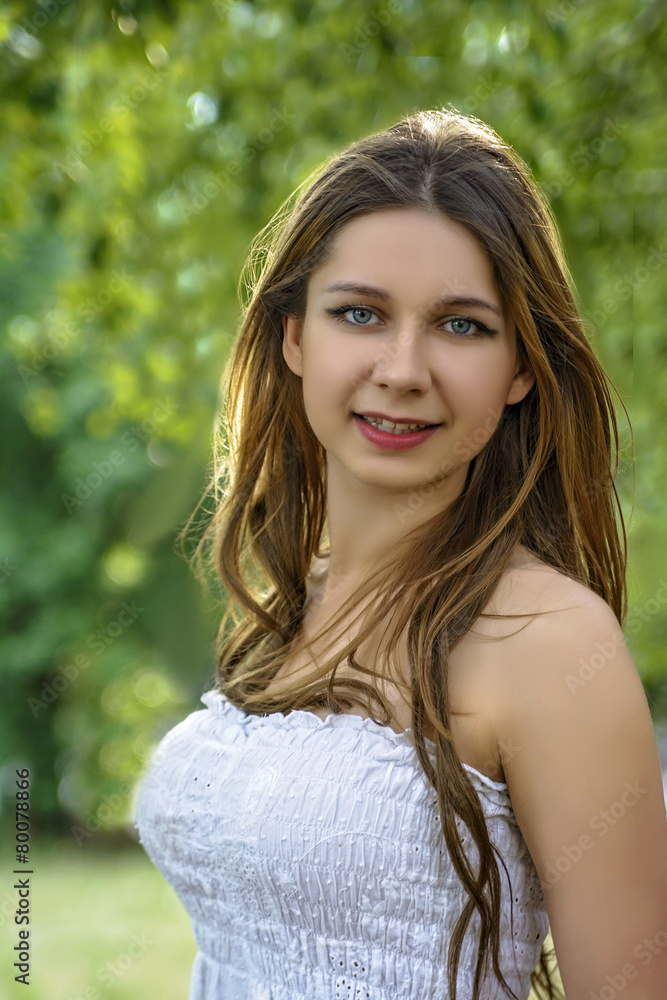 Fototapeta premium girl with long hair embraces a birch