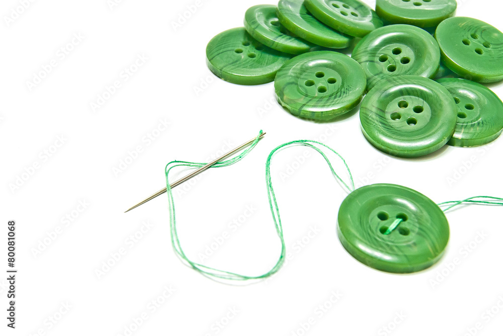 green thread and buttons on white