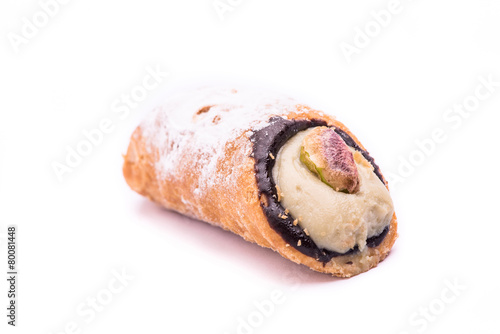"cannolo" italian sicilian pastry with pistachio isolated on whi