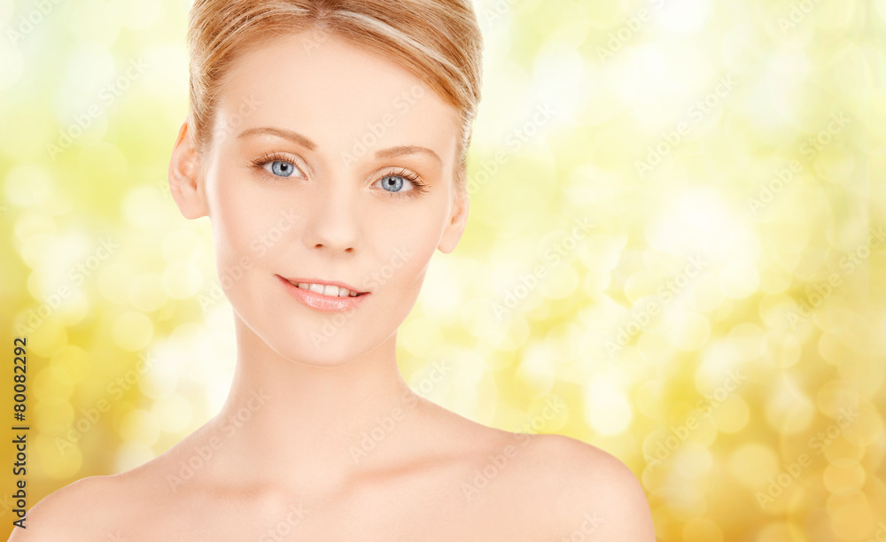 beautiful young woman face over yellow background beautiful young woman face over yellow background