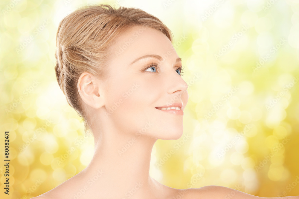 beautiful young woman face over yellow background beautiful young woman face over yellow background