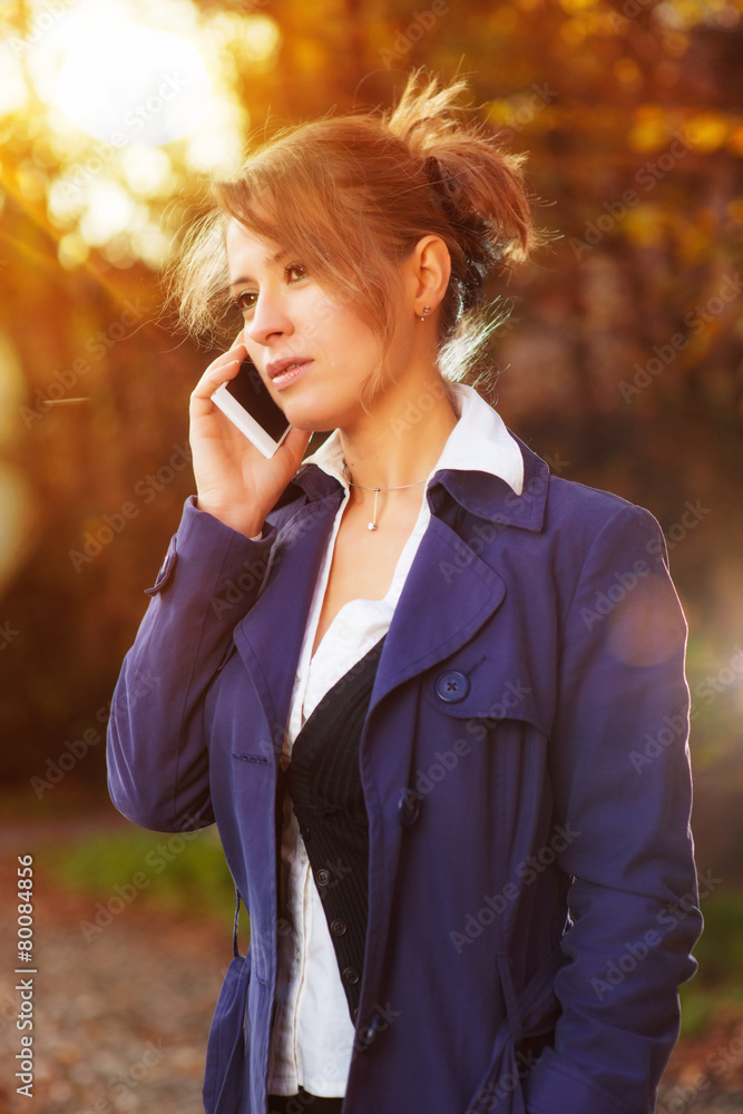 Ragazza triste che utilizza lo smartphone nel parco Ragazza triste che utilizza lo smartphone nel parco