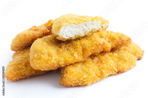 Golden fried chicken strips on white.