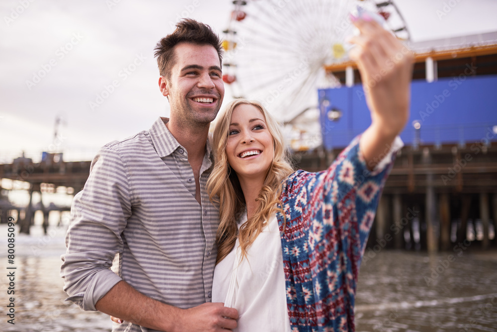 romantic couple taking selfies together in santa monica