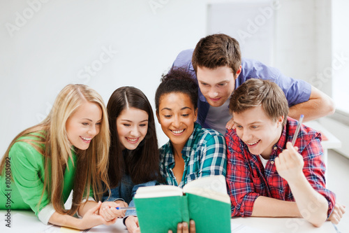 students reading book at school