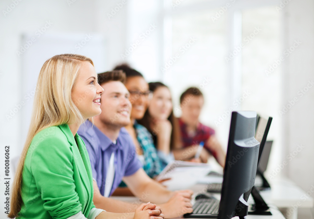 students with computers studying at school