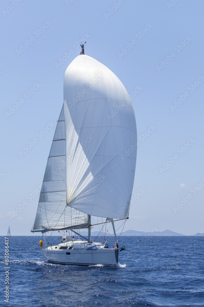 Obraz premium Ship yachts with white sails in the open Sea. Luxury Lifestyle.