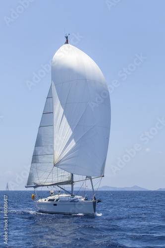 Ship yachts with white sails in the open Sea. Luxury Lifestyle.