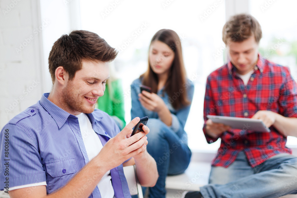 student looking into smartphone at school student looking into smartphone at school