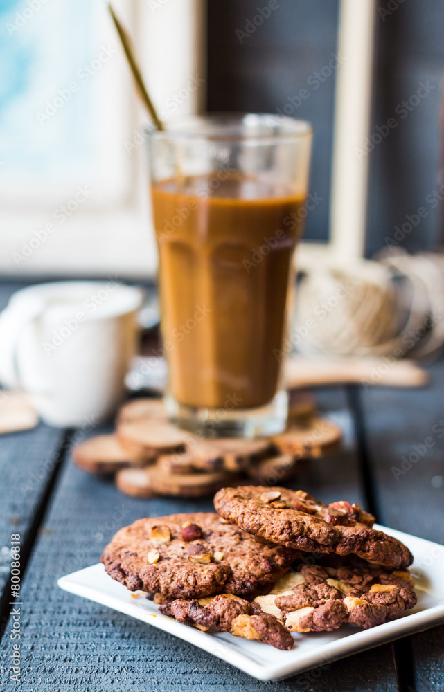 coffee with milk in a glass with a chocolate chip cookie coffee with milk in a glass with a chocolate chip cookie