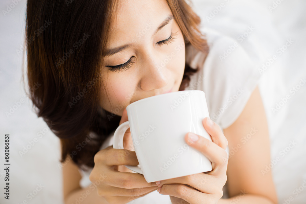 Portrait of a beautiful young woman in bed