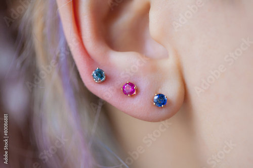 Slika na platnu Woman's ear wearing a beautiful earrings