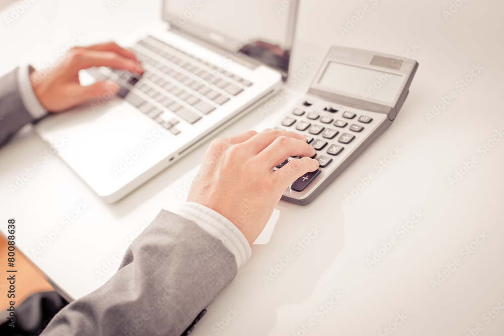 Closeup of businessman hands typing on laptop computer Closeup of businessman hands typing on laptop computer