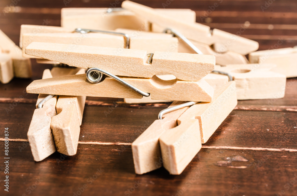 Wooden clothespins on wooden background