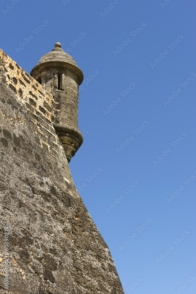 Closeup of Northeastern lookout tower against blue sky.