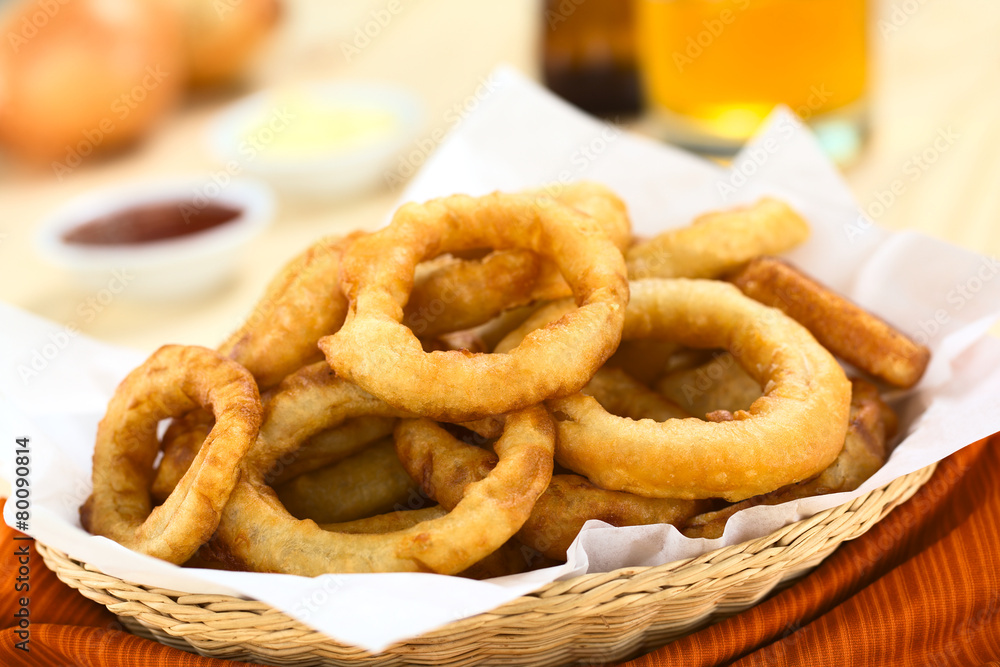 Homemade beer-battered onion rings in a basket Homemade beer-battered onion rings in a basket
