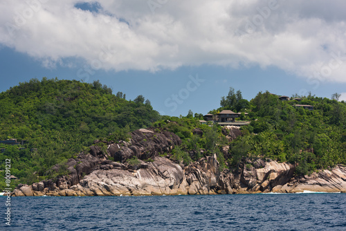 View of Seychelles coastline with houses in the forest © dvoevnore