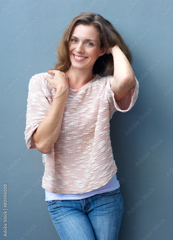 Attractive mid adult woman smiling with hand in hair Attractive mid adult woman smiling with hand in hair